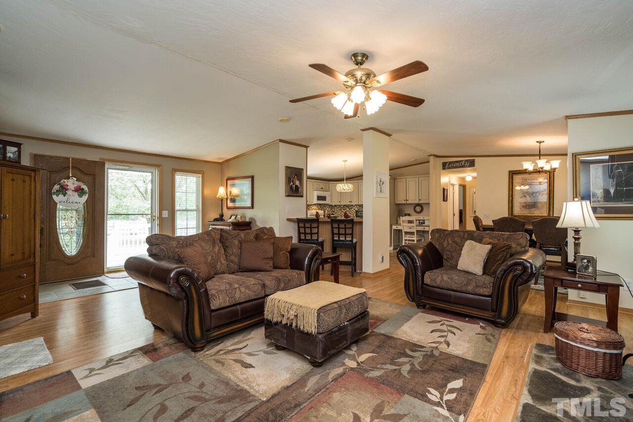7409 Sidecreek Drive Raleigh, NC 27610 - Photo 8 of 29 a living room with furniture and three large window