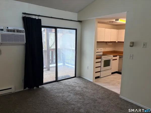 a view of a kitchen with a sink and dishwasher a refrigerator with wooden floor