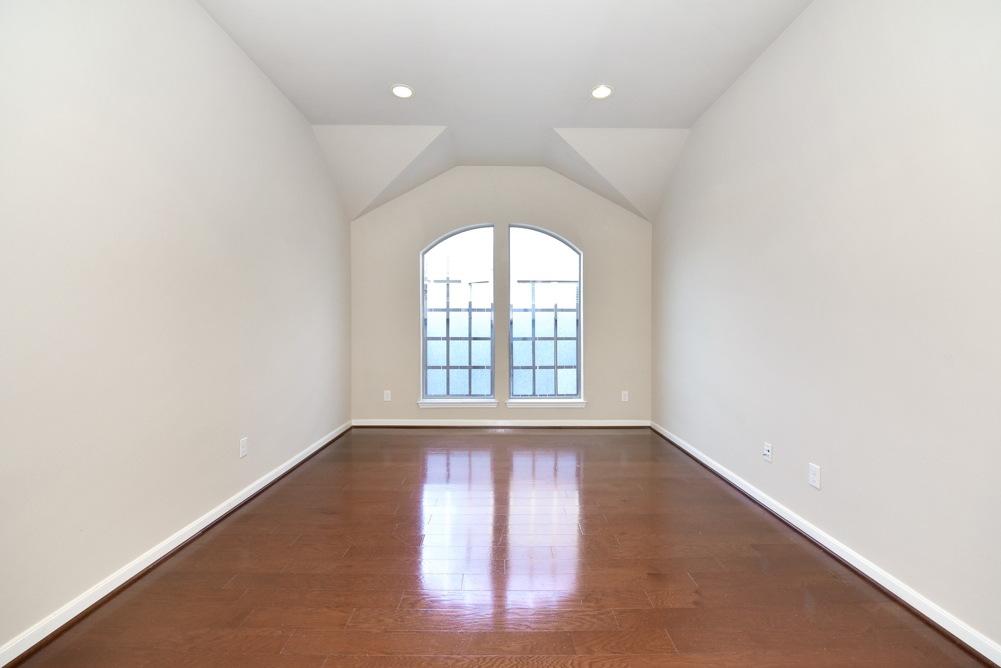 26202 Basil View Lane Katy, TX 77494 - Photo 12 of 29 an empty room with wooden floor and windows