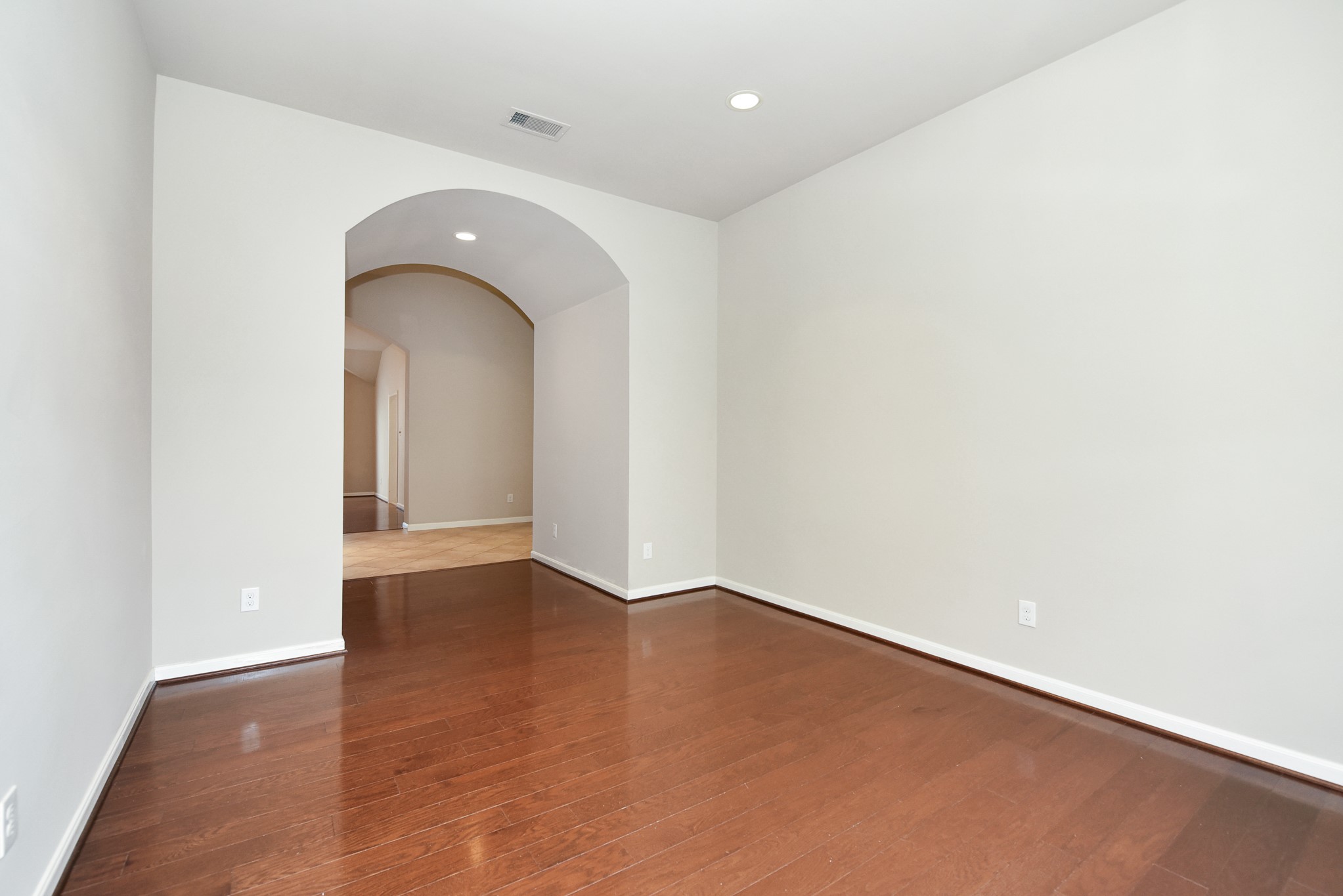 26202 Basil View Lane Katy, TX 77494 - Photo 13 of 29 an empty room with wooden floor and mirror