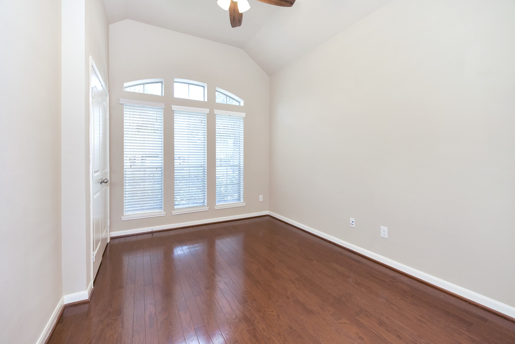 26202 Basil View Lane Katy, TX 77494 - Photo 14 of 29 an empty room with wooden floor and windows
