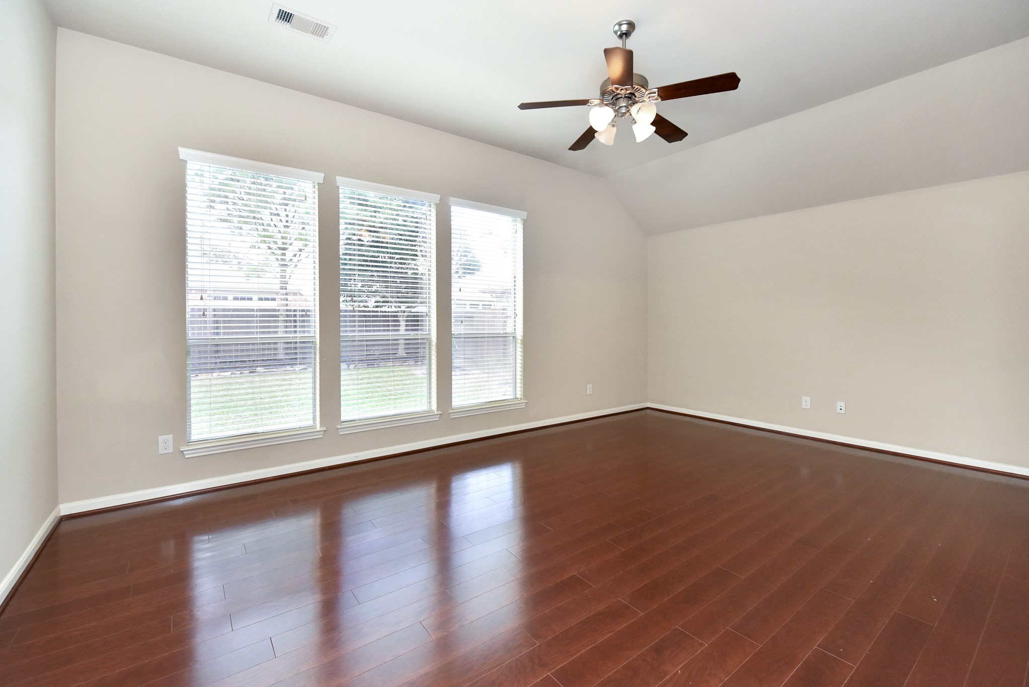 26202 Basil View Lane Katy, TX 77494 - Photo 15 of 29 a view of an empty room with wooden floor and a window
