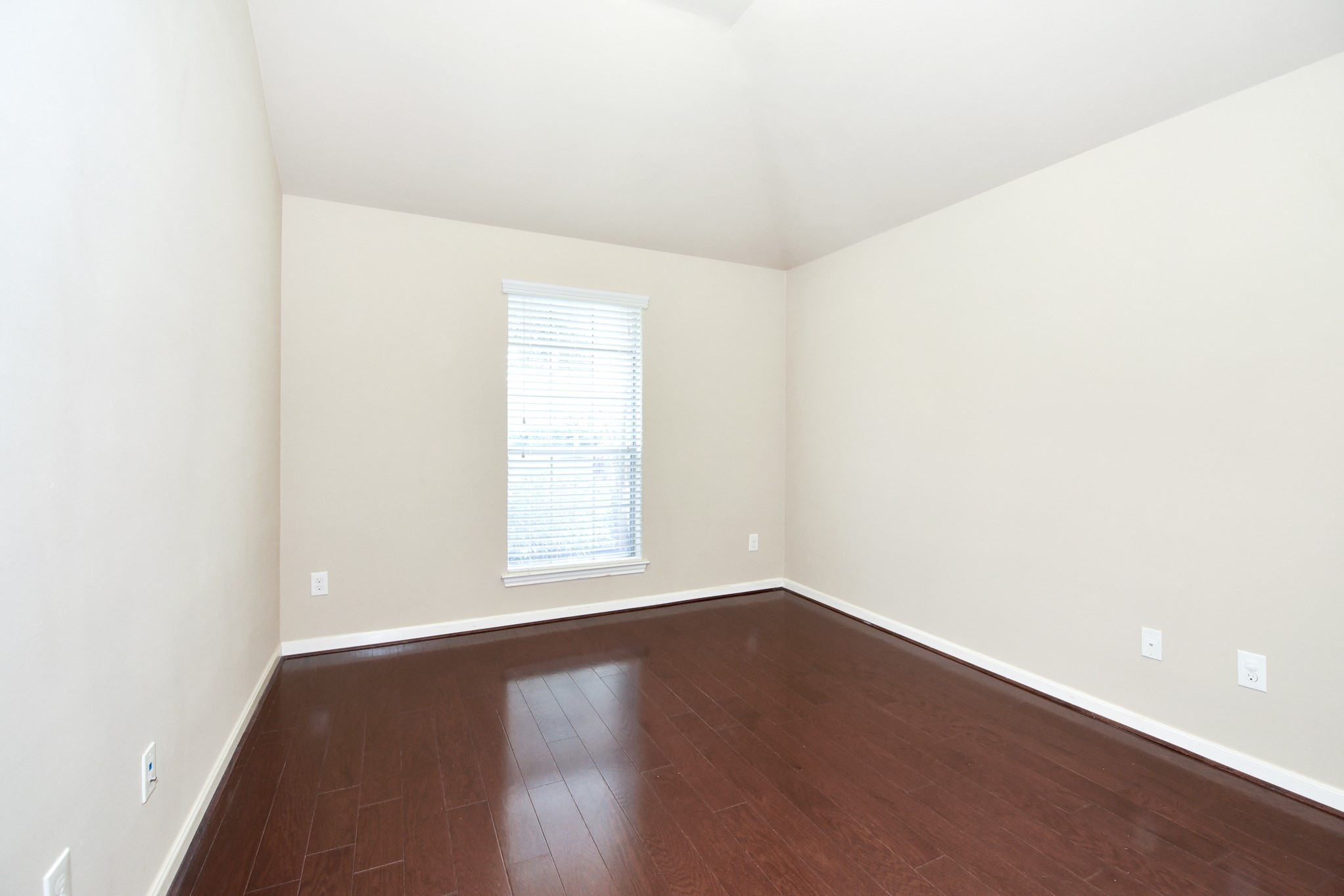 26202 Basil View Lane Katy, TX 77494 - Photo 19 of 29 an empty room with wooden floor and windows