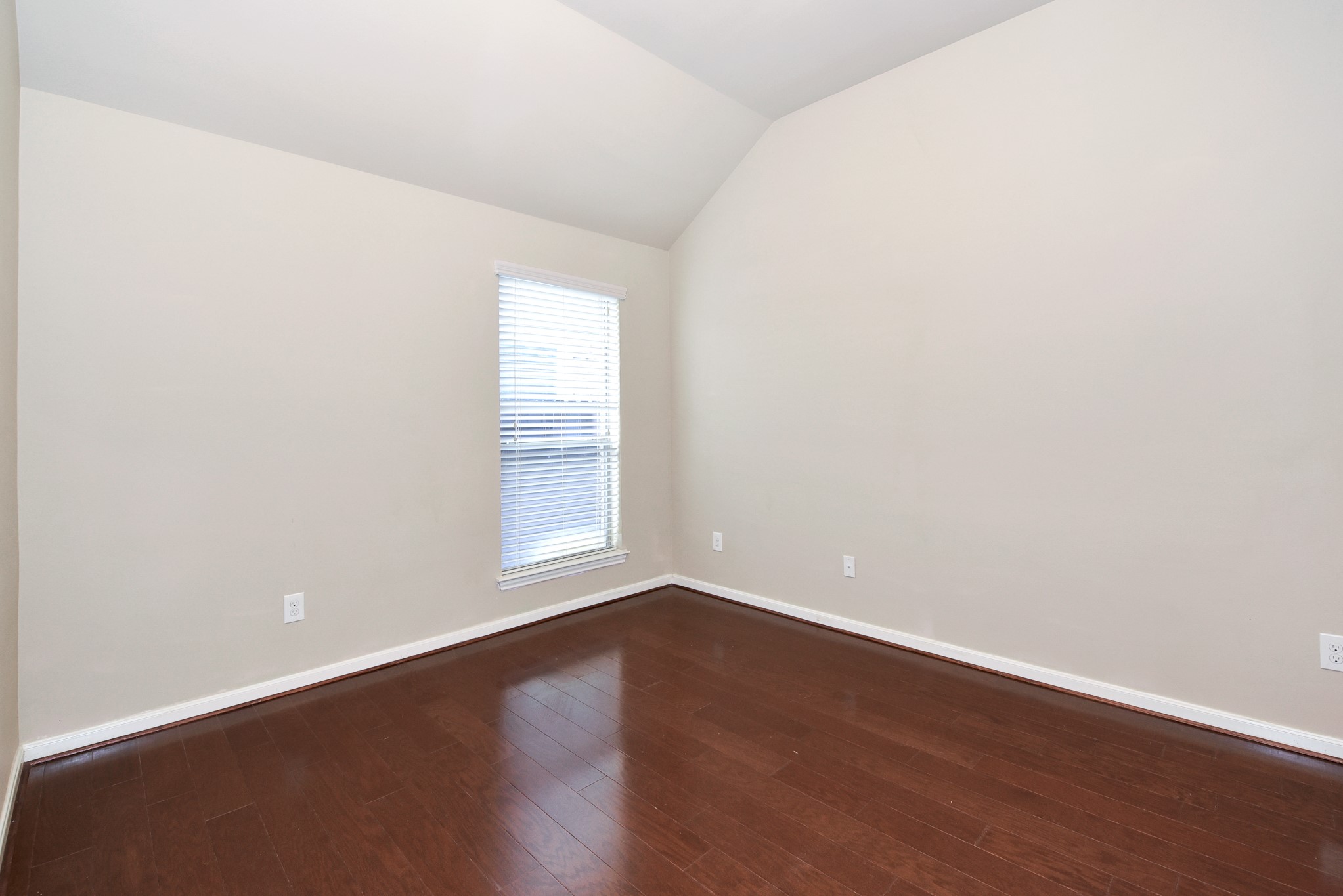 26202 Basil View Lane Katy, TX 77494 - Photo 21 of 29 an empty room with wooden floor and windows