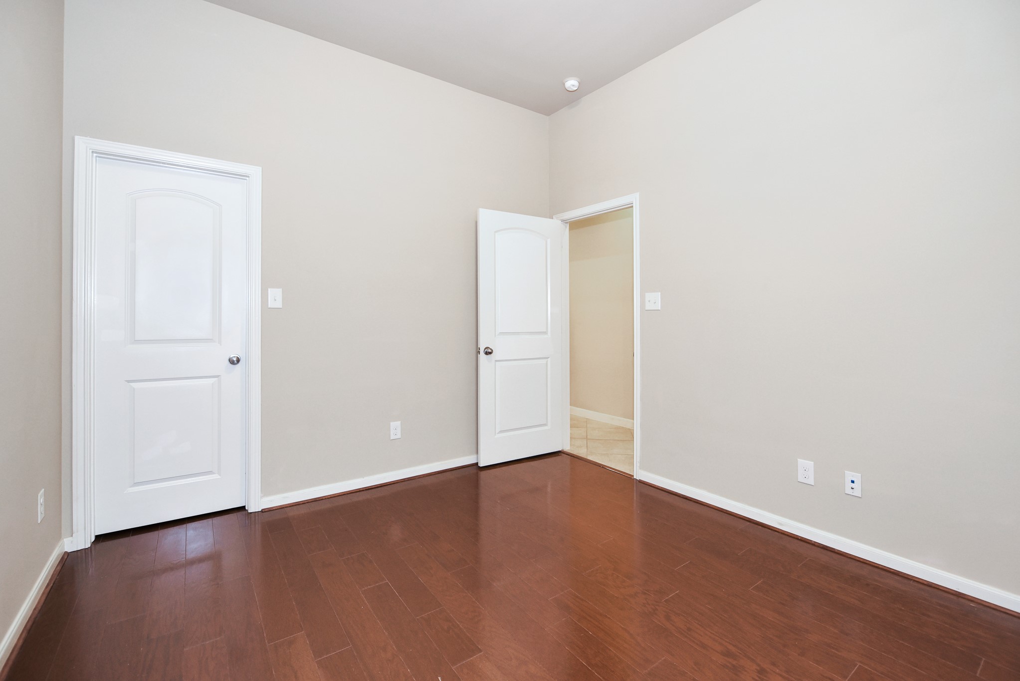 26202 Basil View Lane Katy, TX 77494 - Photo 22 of 29 an empty room with wooden floor and windows