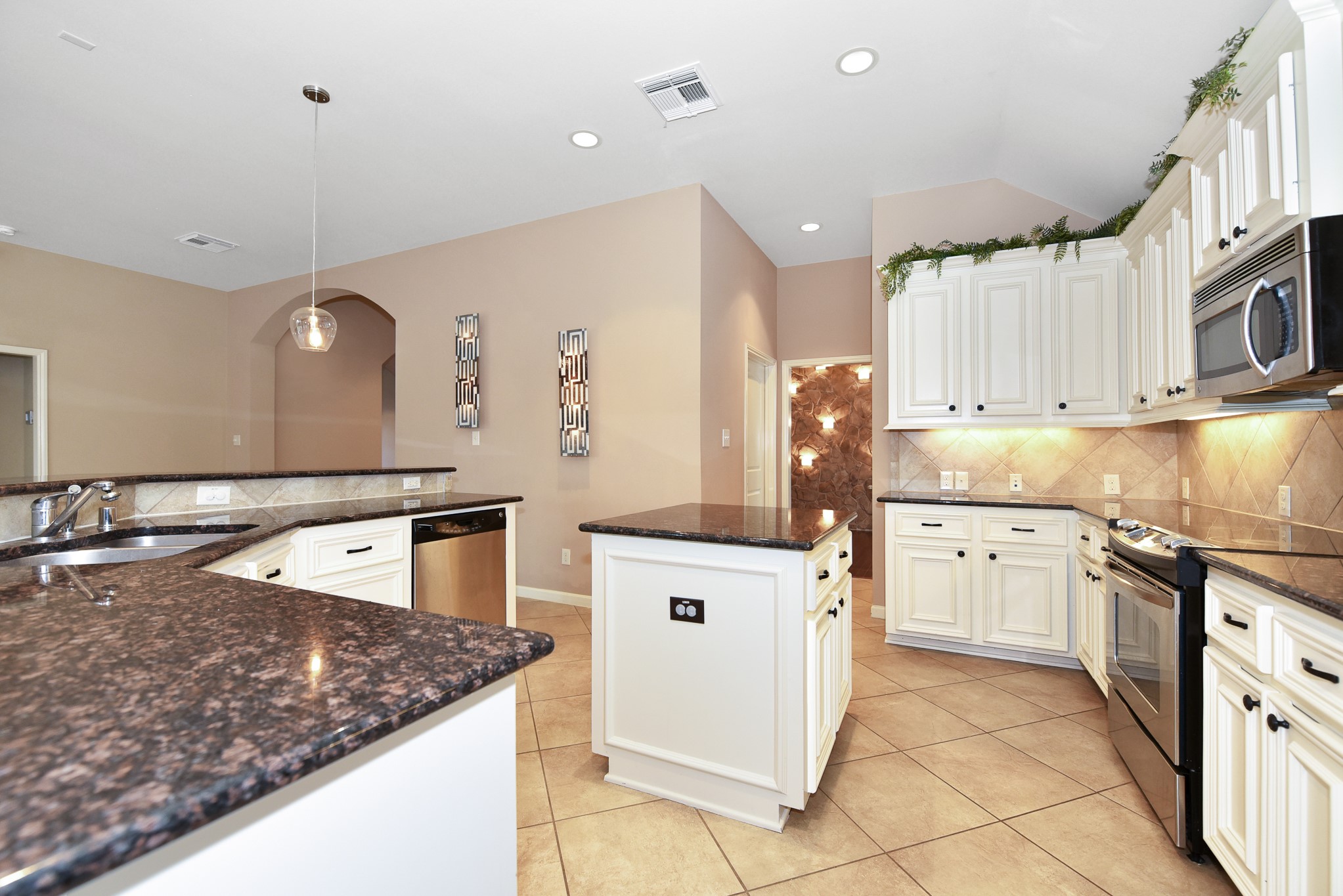 26202 Basil View Lane Katy, TX 77494 - Photo 8 of 29 a kitchen with stainless steel appliances granite countertop a sink and a stove