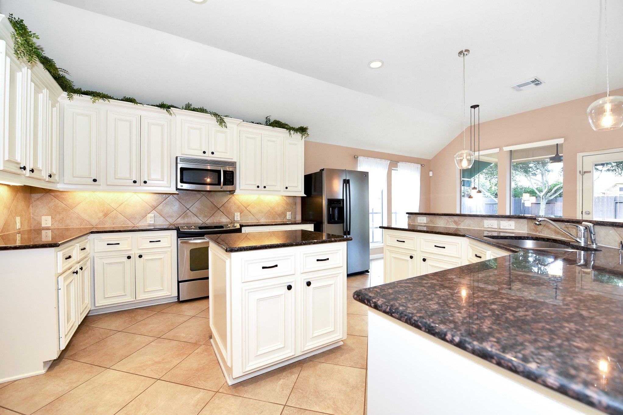 26202 Basil View Lane Katy, TX 77494 - Photo 9 of 29 a kitchen with stainless steel appliances granite countertop a sink stove and refrigerator