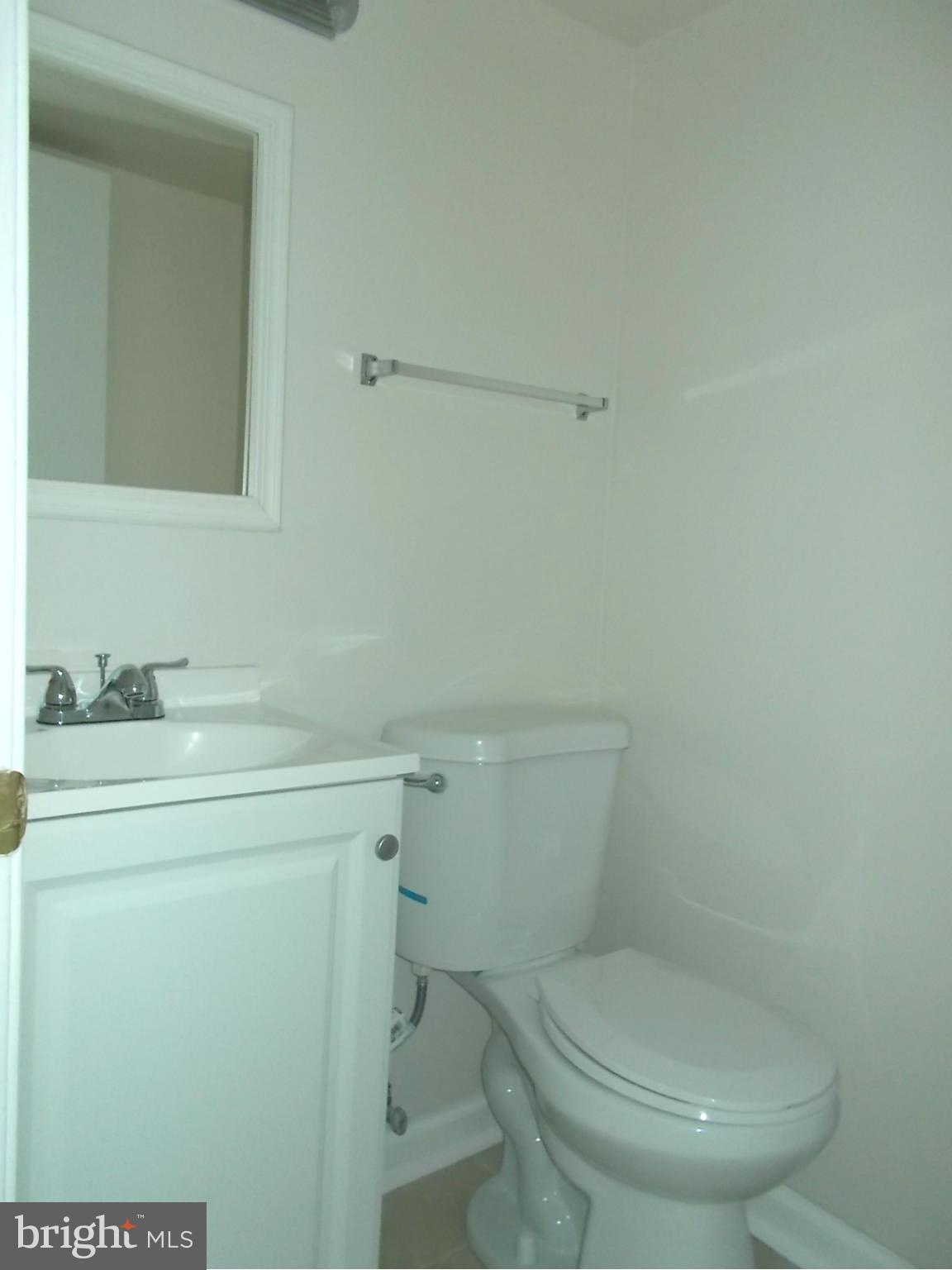 3529 Falling Green Road Olney, MD 20832 - Photo 14 of 16 a bathroom with a toilet a sink and mirror