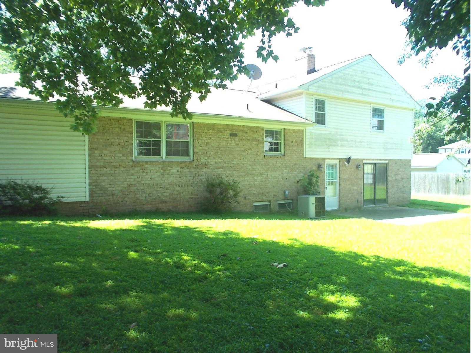 3529 Falling Green Road Olney, MD 20832 - Photo 4 of 16 a view of a yard in front of a house with large tree