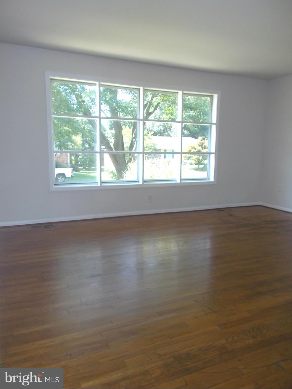 3529 Falling Green Road Olney, MD 20832 - Photo 6 of 16 a view of a room with wooden floor and a window