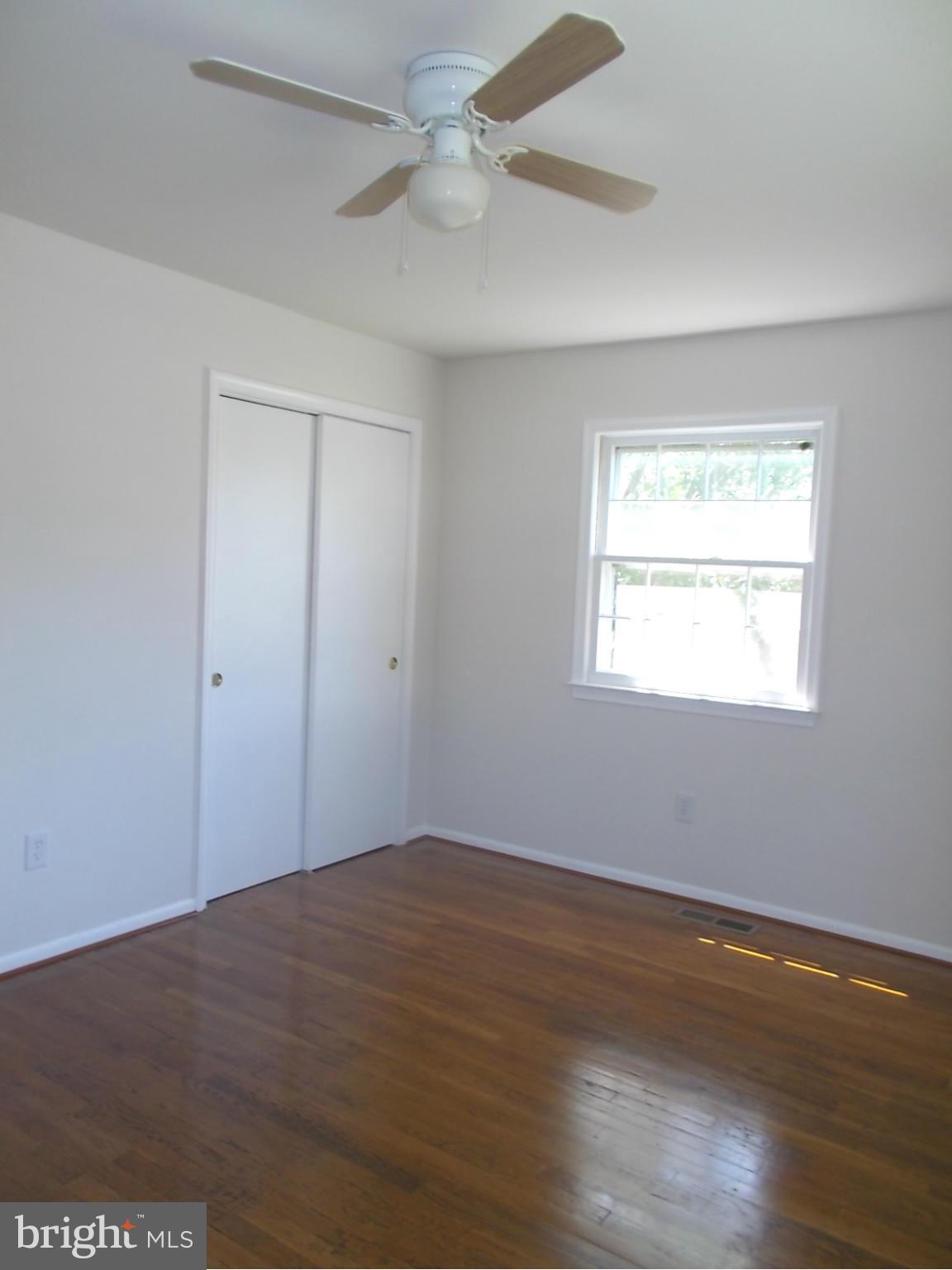3529 Falling Green Road Olney, MD 20832 - Photo 10 of 16 a view of empty room with wooden floor and fan