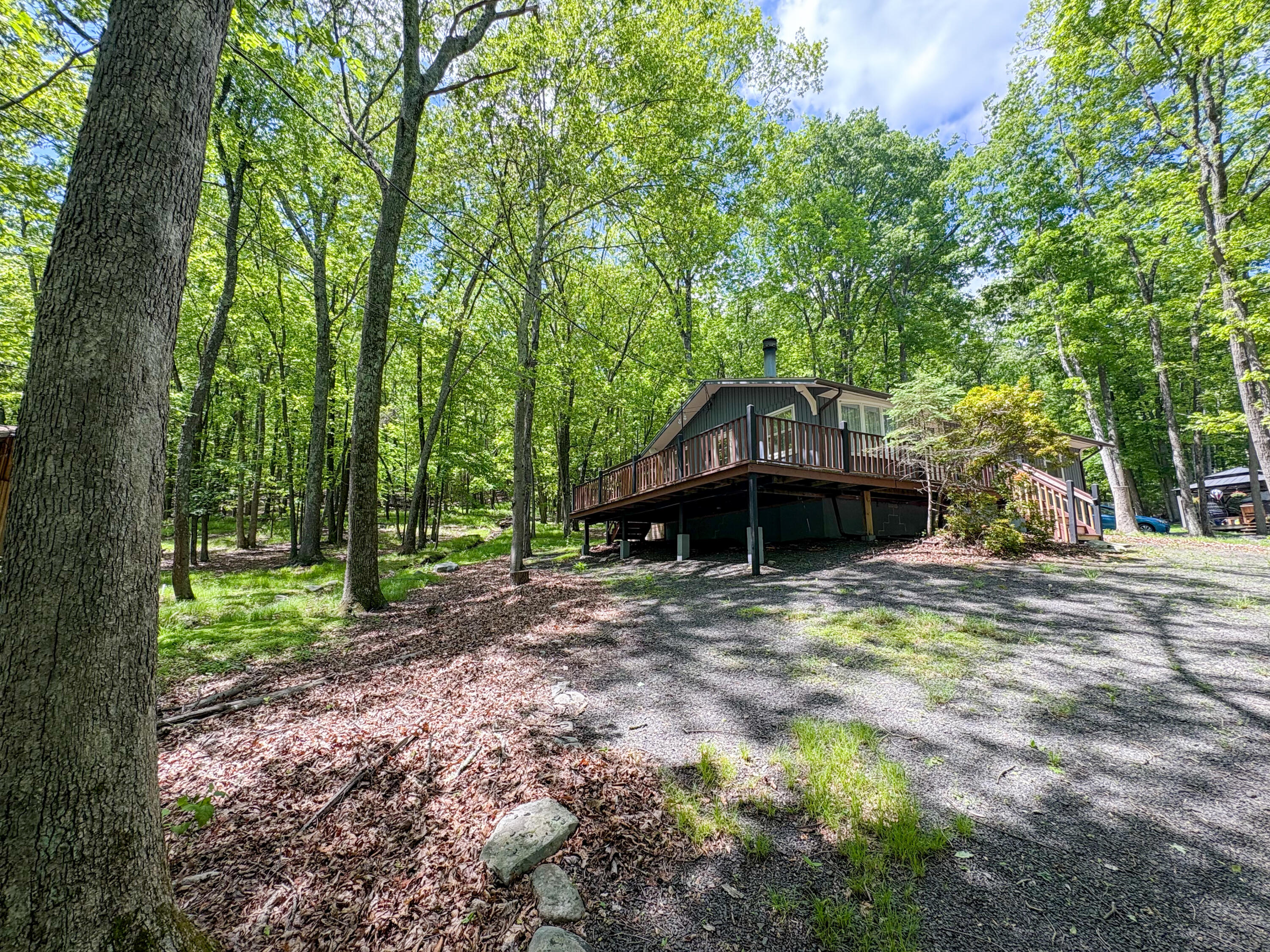 1085 Maple Lake Drive Bushkill, PA 18324 - Photo 22 of 35 a house with trees in the background