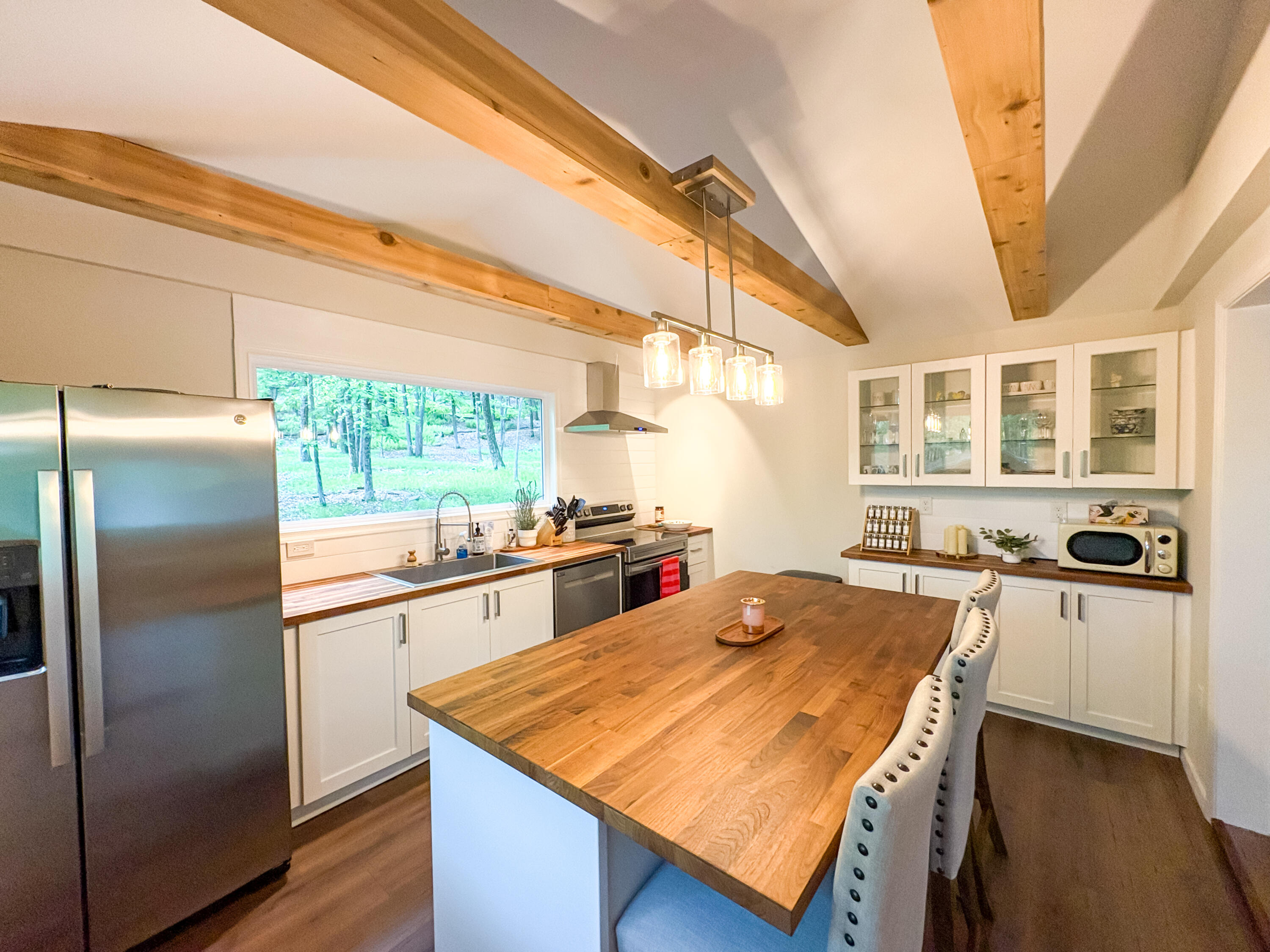 1085 Maple Lake Drive Bushkill, PA 18324 - Photo 6 of 35 a kitchen with stainless steel appliances granite countertop a refrigerator a sink dishwasher and white countertops with wooden floor