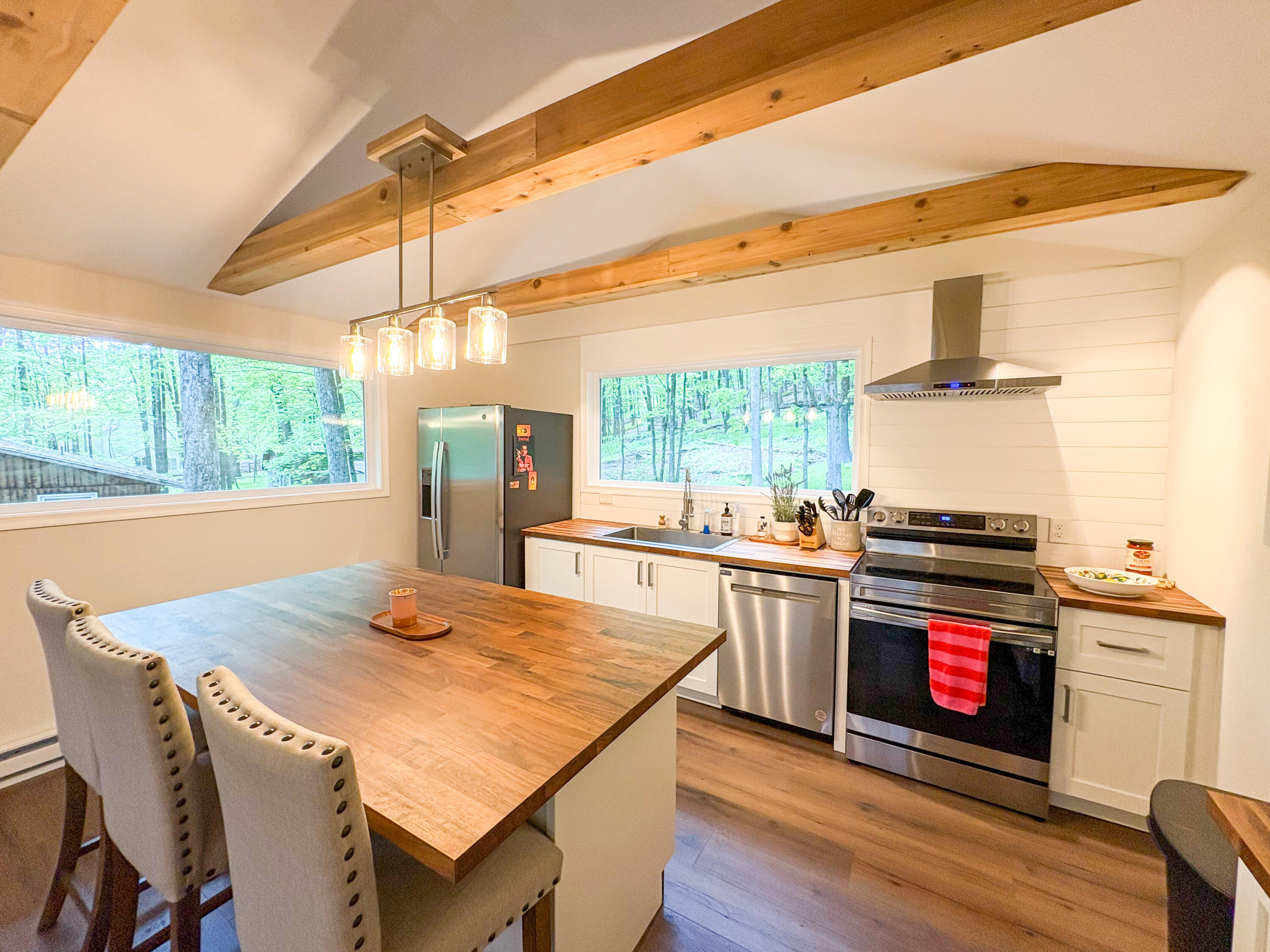 1085 Maple Lake Drive Bushkill, PA 18324 - Photo 7 of 35 a kitchen with stainless steel appliances wooden floor dining table and chairs