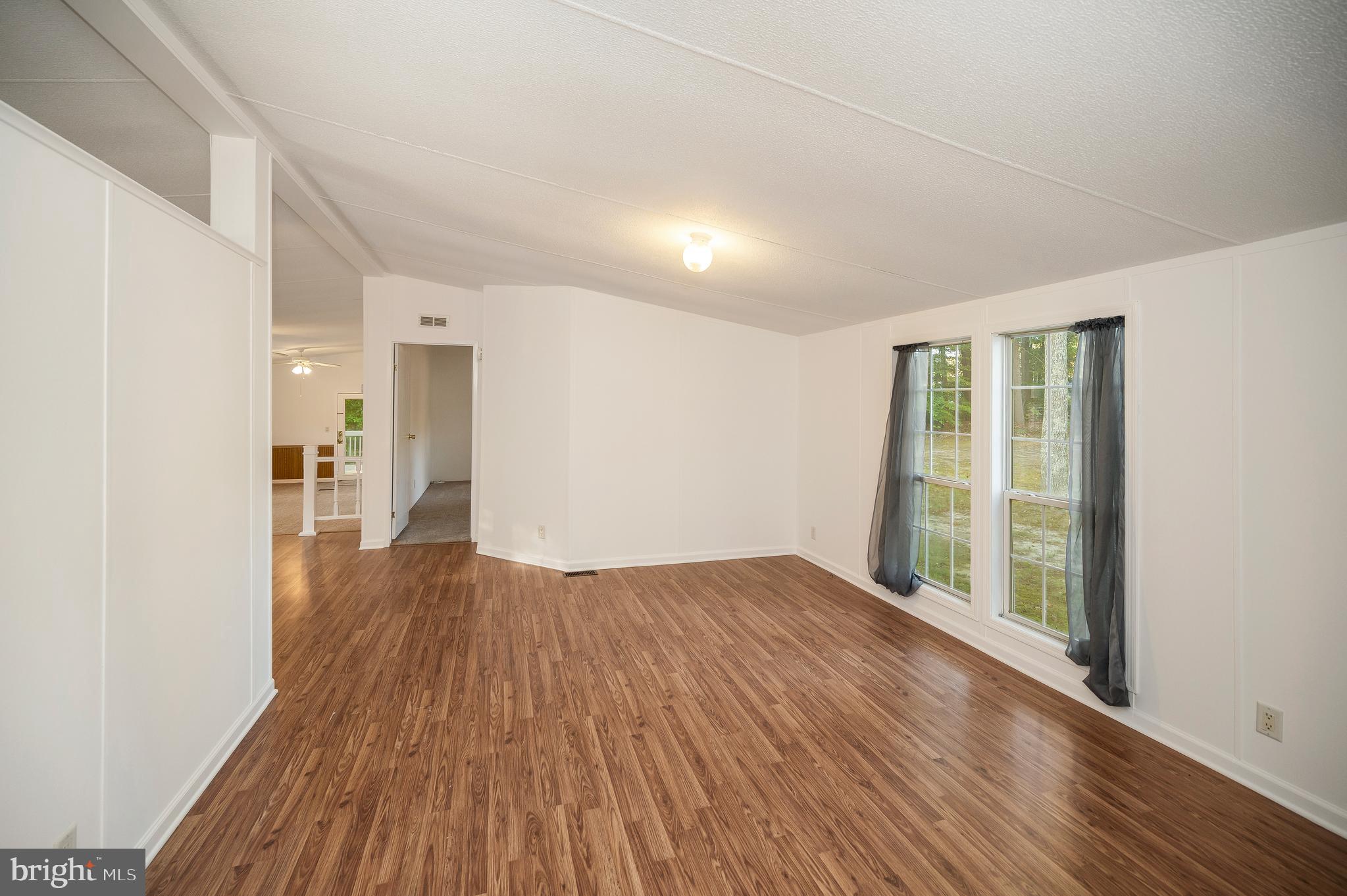 9863 Red Hill Road Spotsylvania, VA 22553 - Photo 11 of 53 a view of empty room with wooden floor and fan