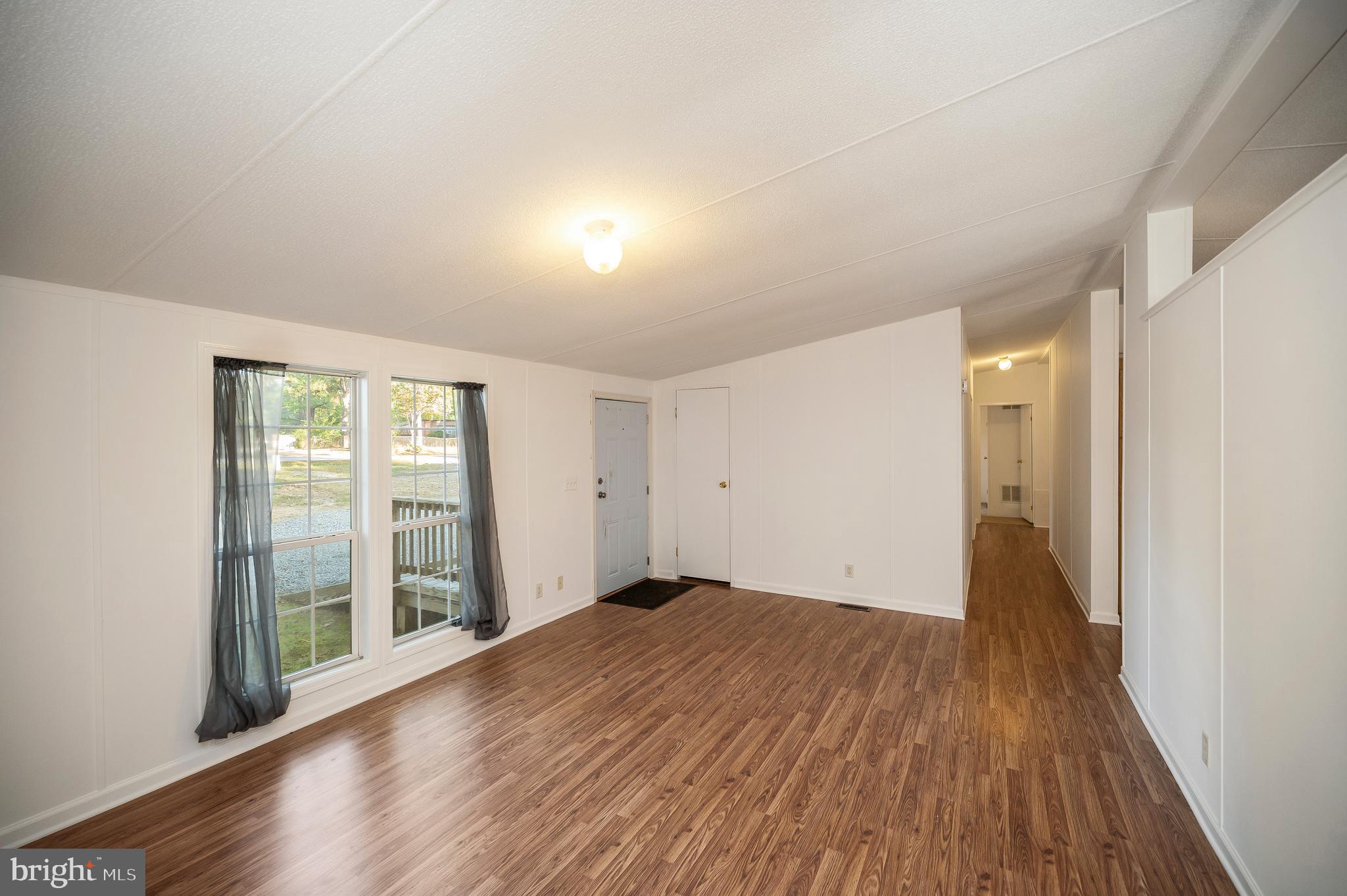 9863 Red Hill Road Spotsylvania, VA 22553 - Photo 12 of 53 wooden floor in an empty room with a window