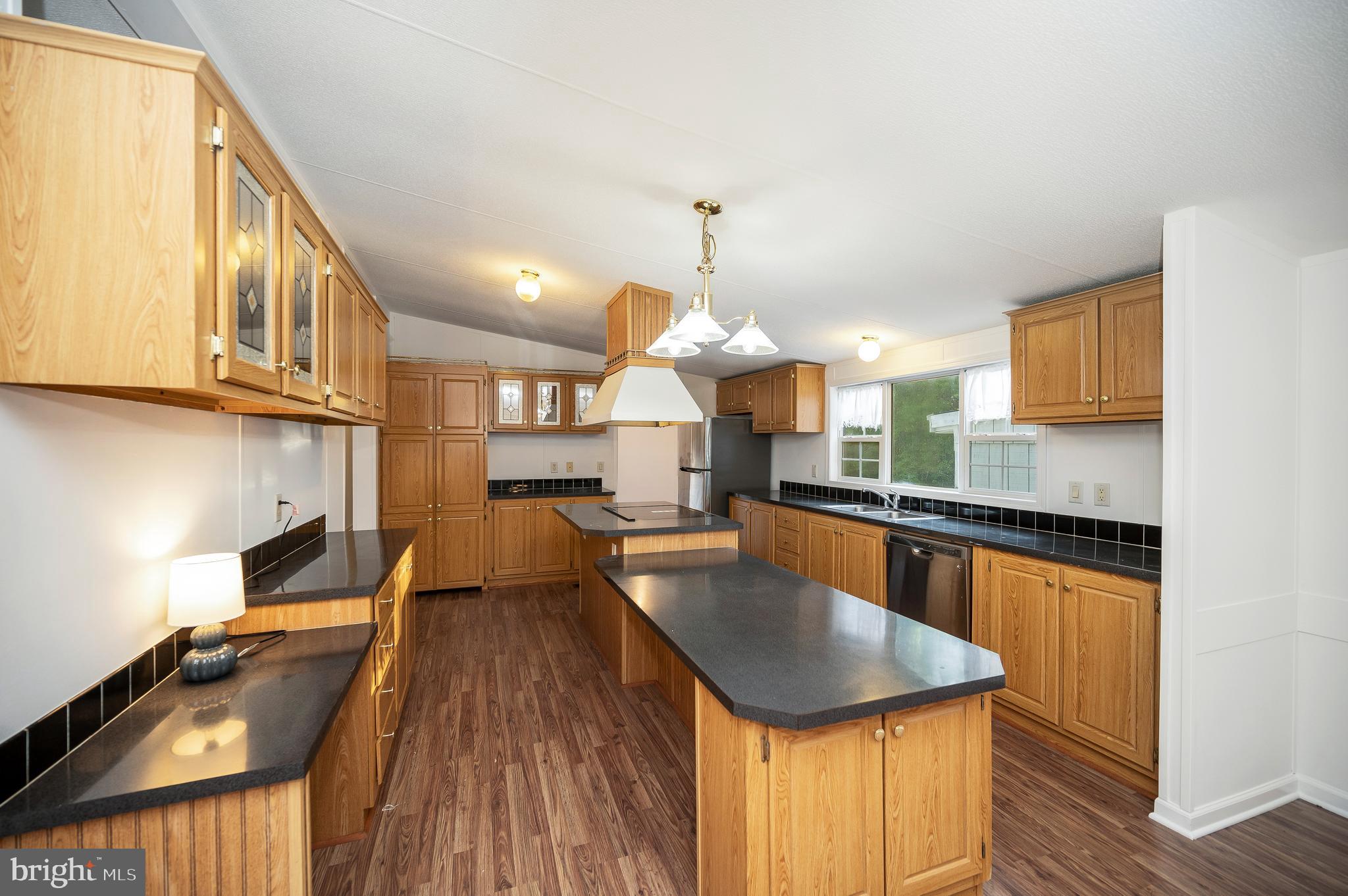 9863 Red Hill Road Spotsylvania, VA 22553 - Photo 17 of 53 a kitchen with counter top space a sink appliances and cabinets