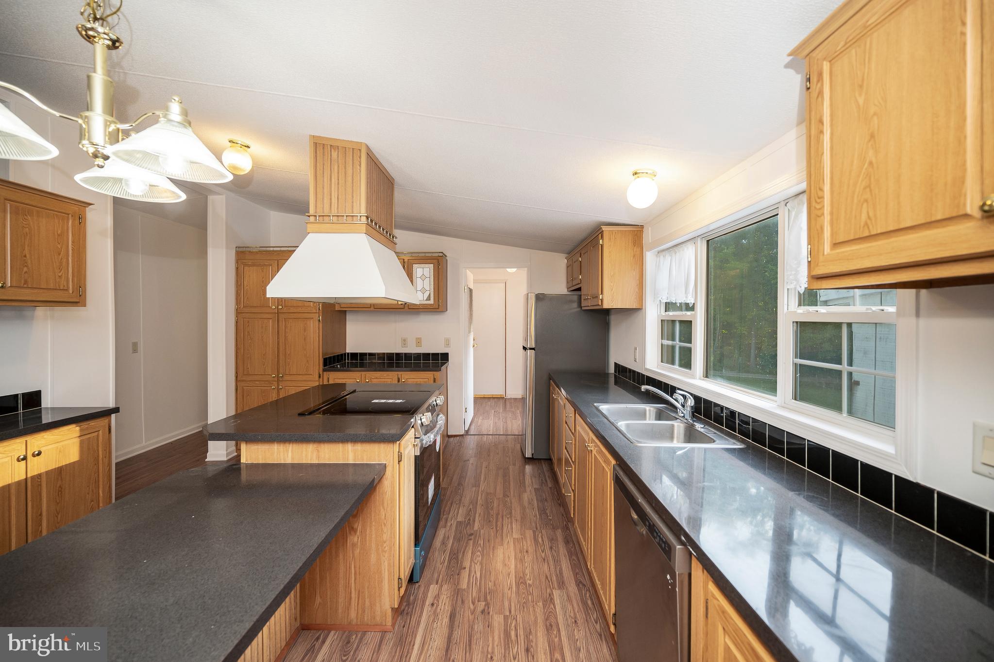 9863 Red Hill Road Spotsylvania, VA 22553 - Photo 19 of 53 a kitchen with stainless steel appliances granite countertop a stove a sink and a microwave