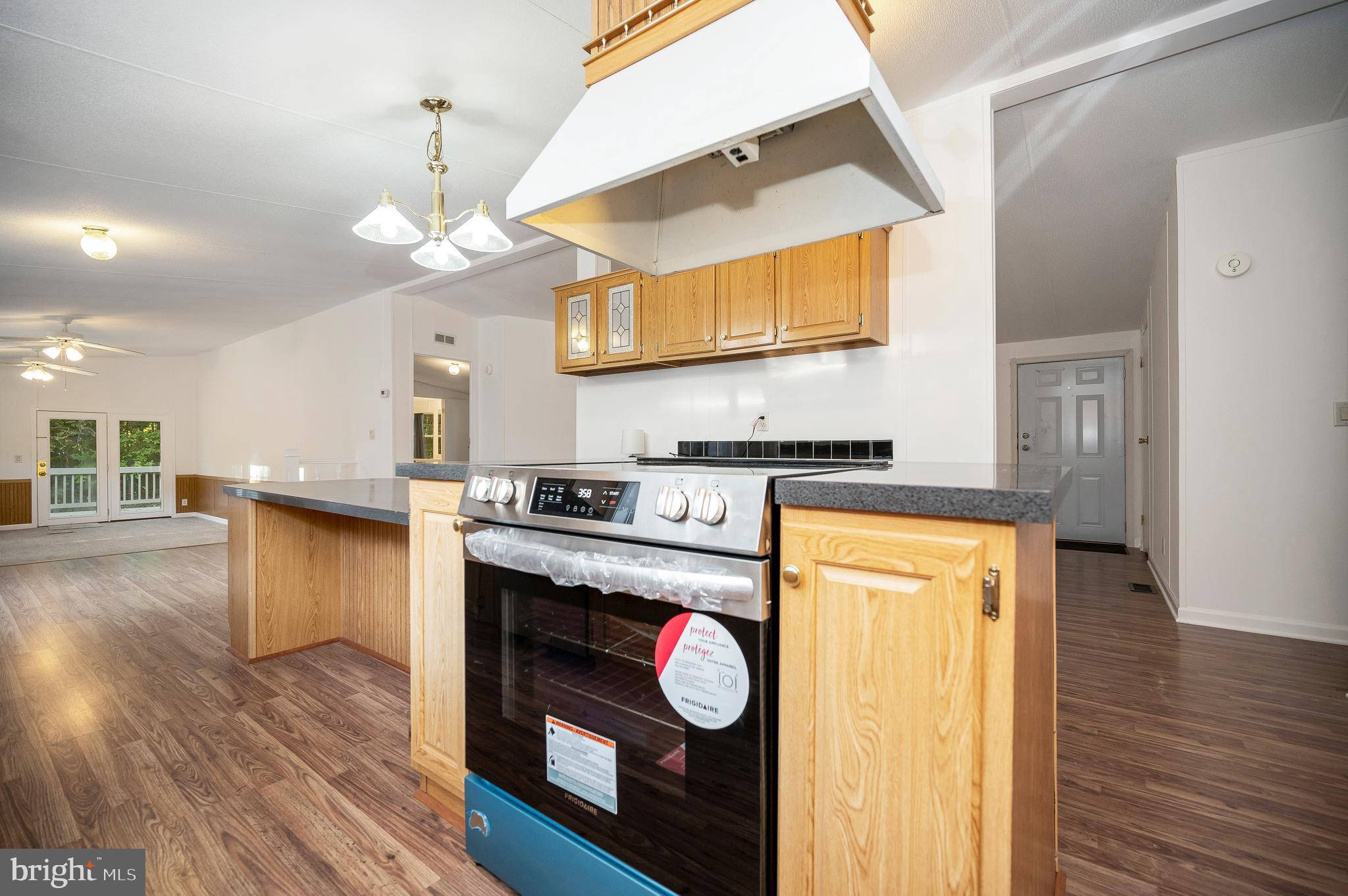 9863 Red Hill Road Spotsylvania, VA 22553 - Photo 22 of 53 a kitchen with granite countertop wooden floors and a sink