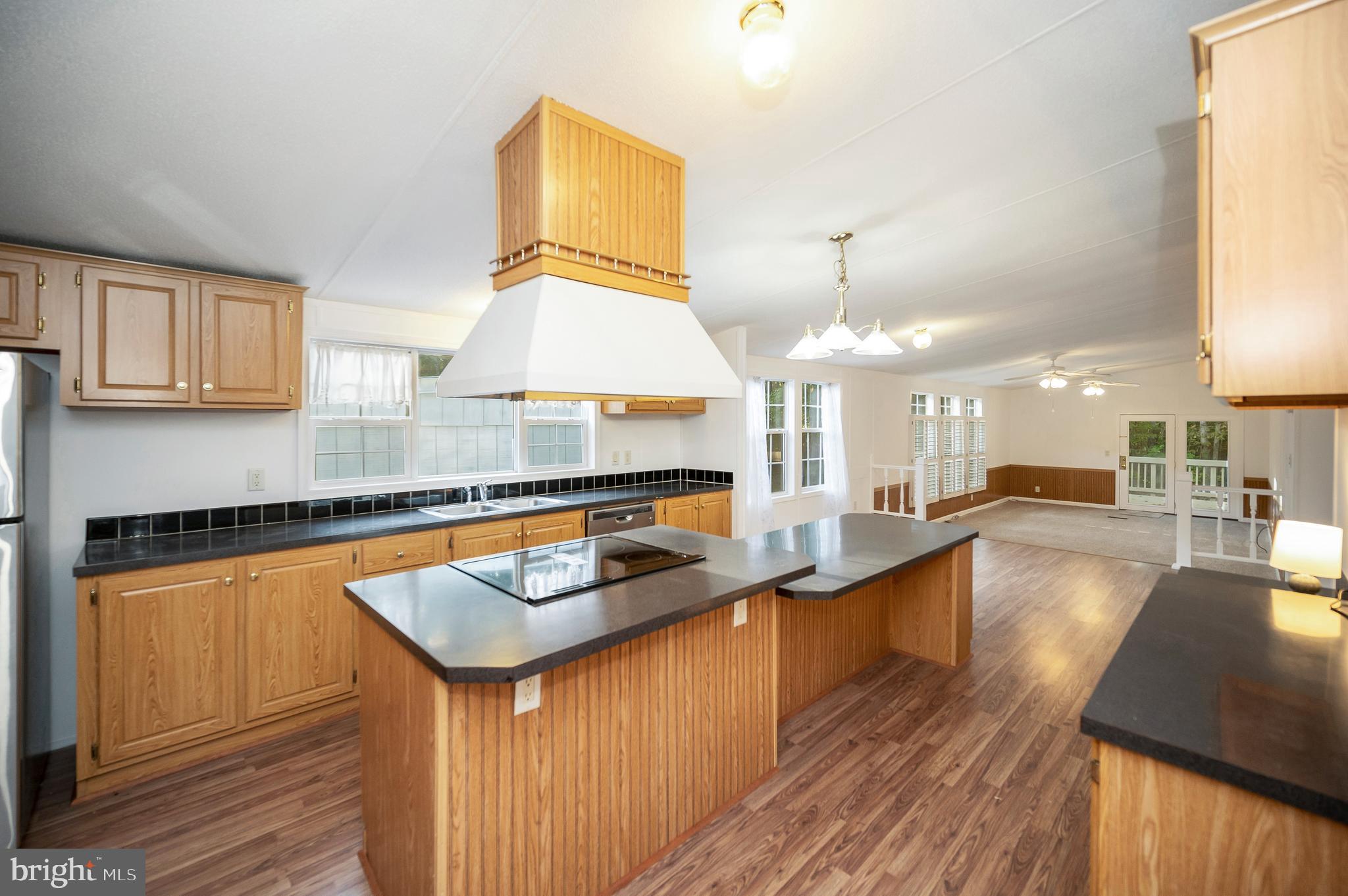 9863 Red Hill Road Spotsylvania, VA 22553 - Photo 23 of 53 a kitchen with counter top space a sink stove and cabinets