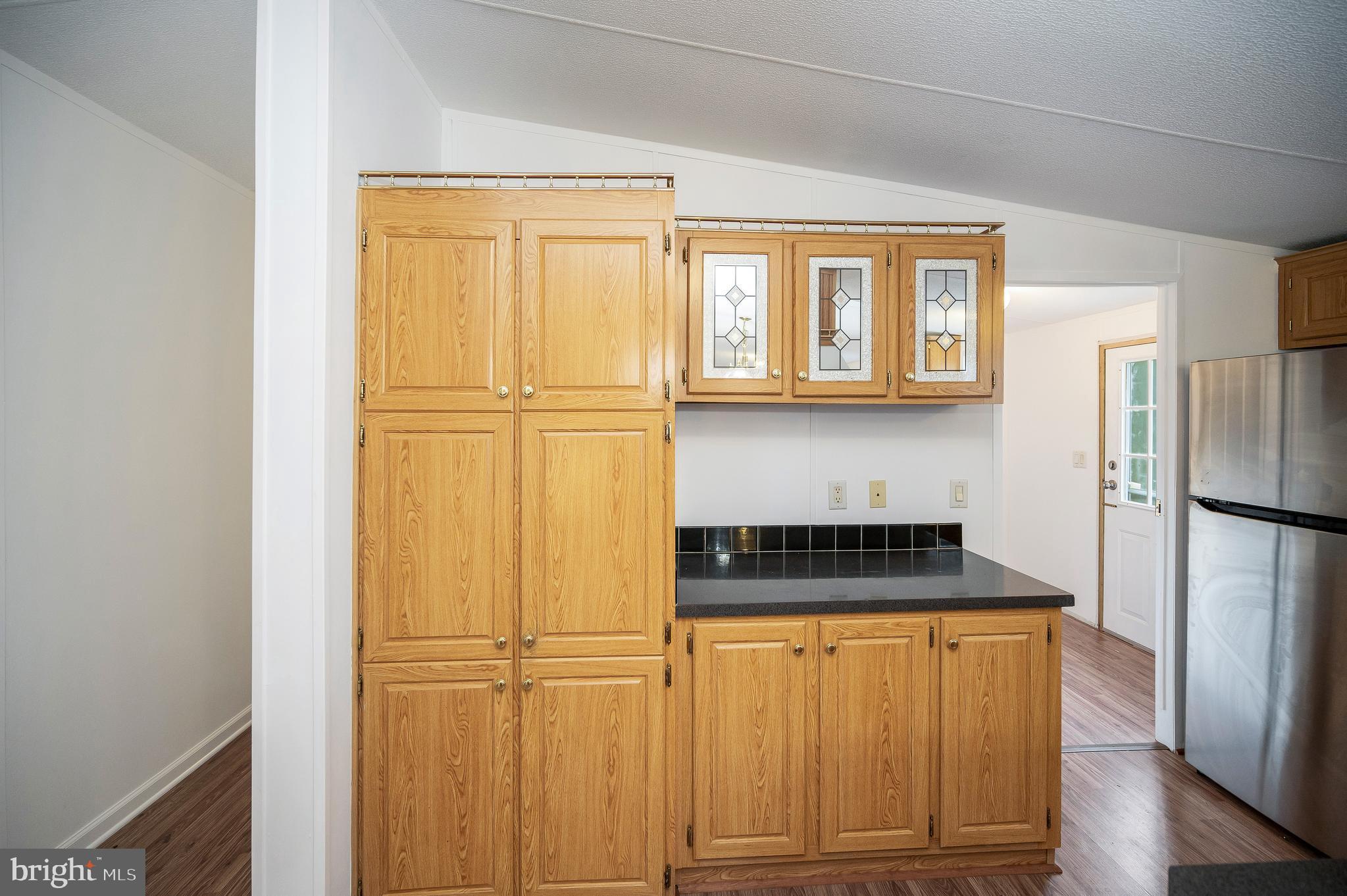 9863 Red Hill Road Spotsylvania, VA 22553 - Photo 24 of 53 a kitchen with a refrigerator and a stove top oven