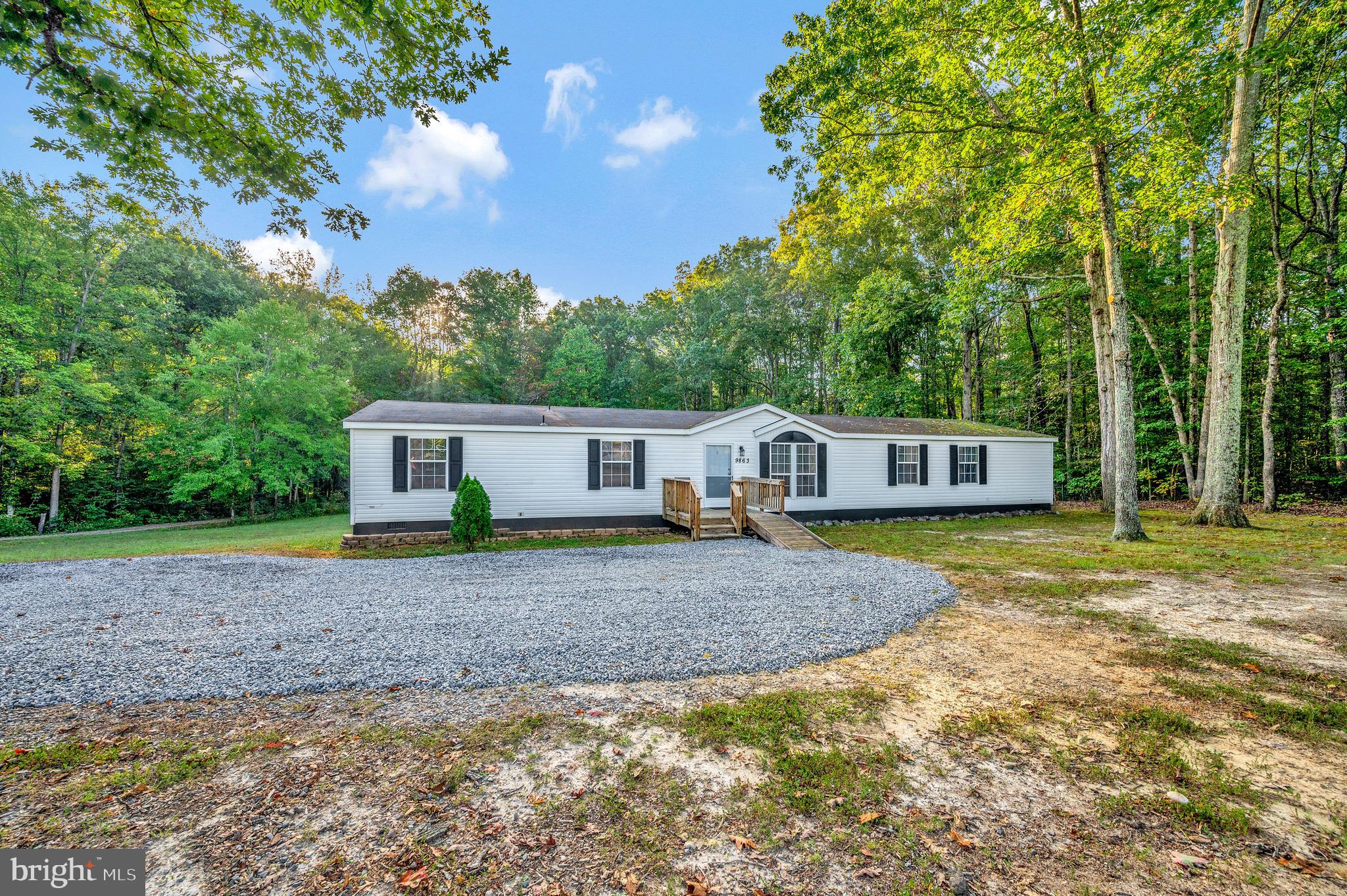 9863 Red Hill Road Spotsylvania, VA 22553 - Photo 4 of 53 a front view of a house with a garden