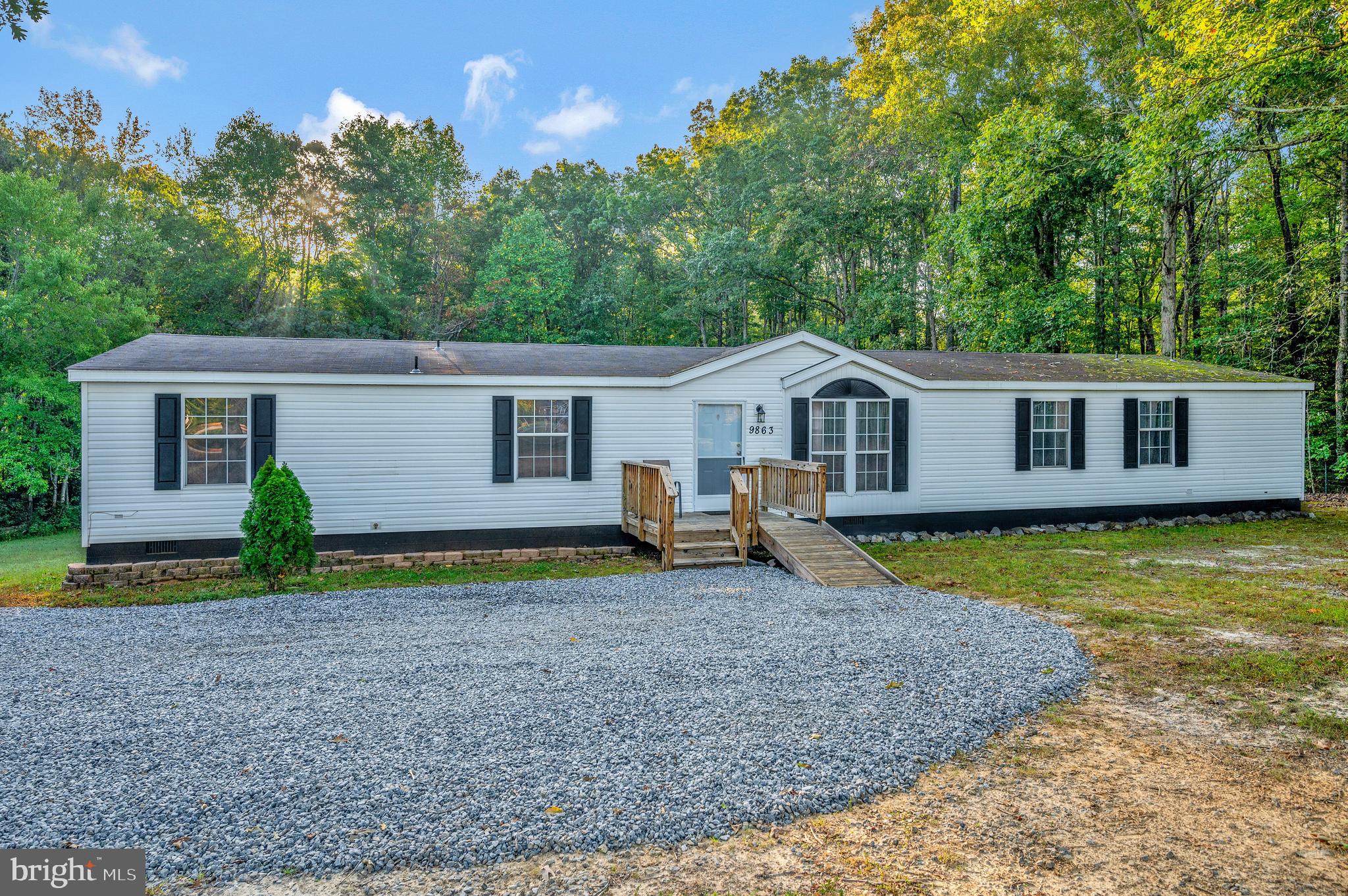 9863 Red Hill Road Spotsylvania, VA 22553 - Photo 5 of 53 a front view of a house with a yard and trees