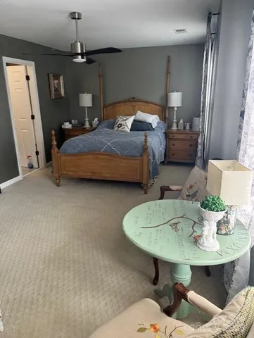 a bedroom with bed and a chair