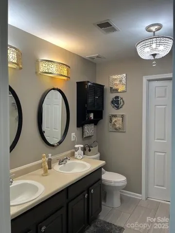 a bathroom with a toilet a sink and a mirror