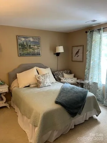 a bedroom with bed and a window