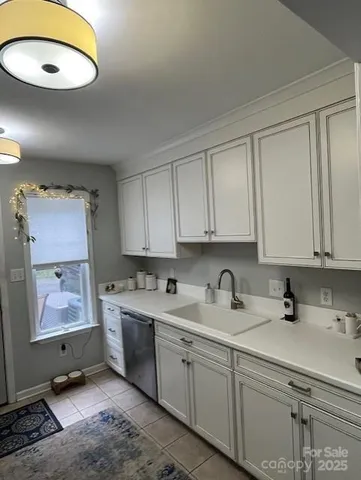 a kitchen with a sink cabinets and window