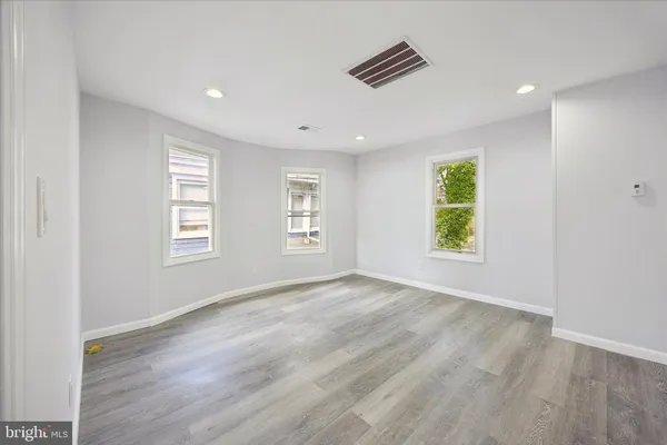 an empty room with windows and closet