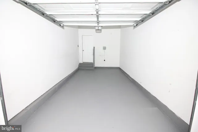 a view of a room with a ceiling fan and window