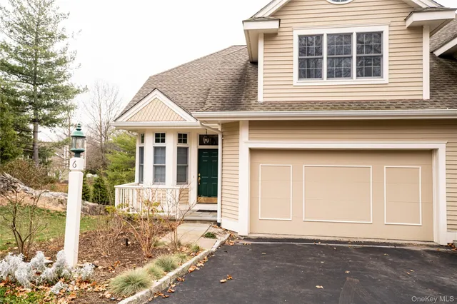a front view of a house with a floor to ceiling windows