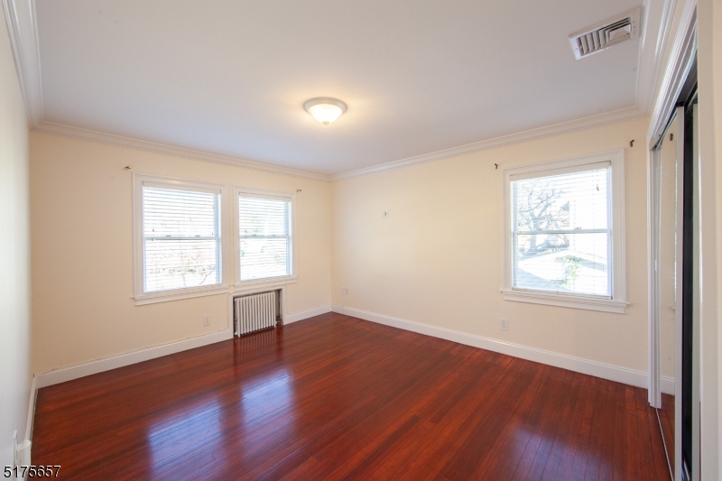 16 Columbus Avenue Glen Ridge, NJ 07028 - Photo 6 of 14 an empty room with wooden floor and windows