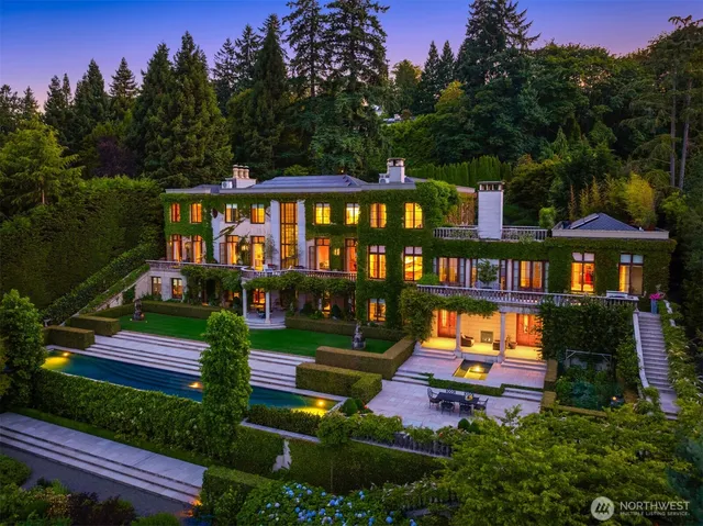 a backyard of a house with table and chairs in a garden