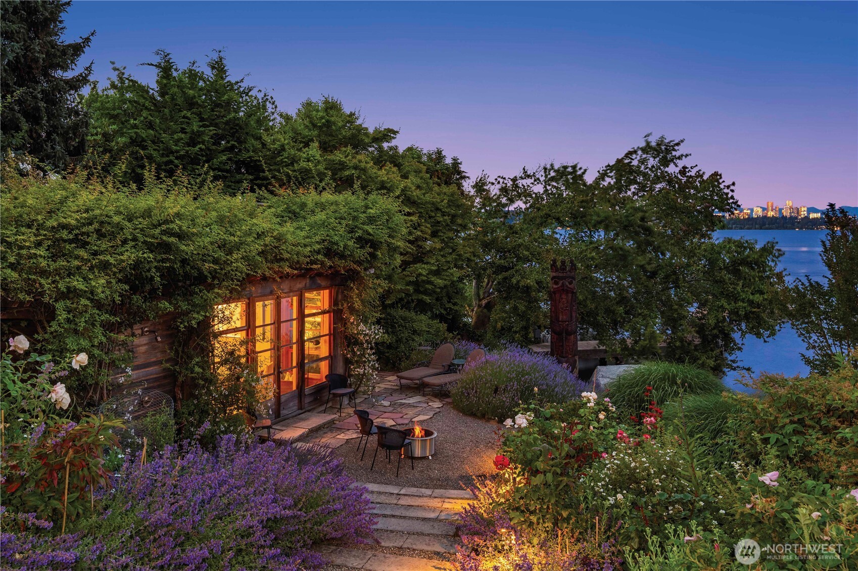 Undisclosed Address Seattle, WA 98112 - Photo 13 of 15 a backyard of a house with table and chairs in a garden