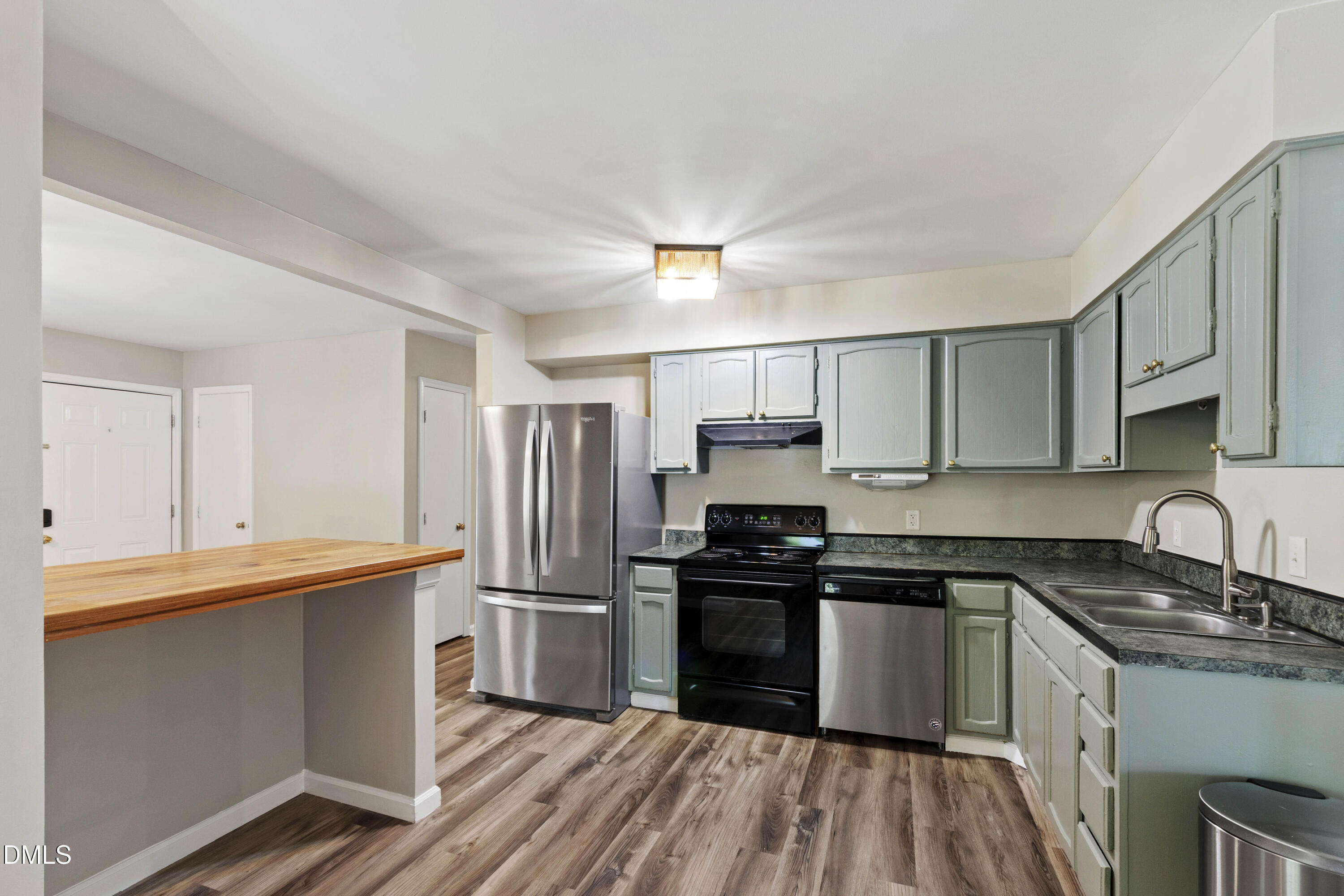 2415 Dorety Place Raleigh, NC 27604 - Photo 29 of 53 a kitchen with stainless steel appliances granite countertop a sink stove and refrigerator