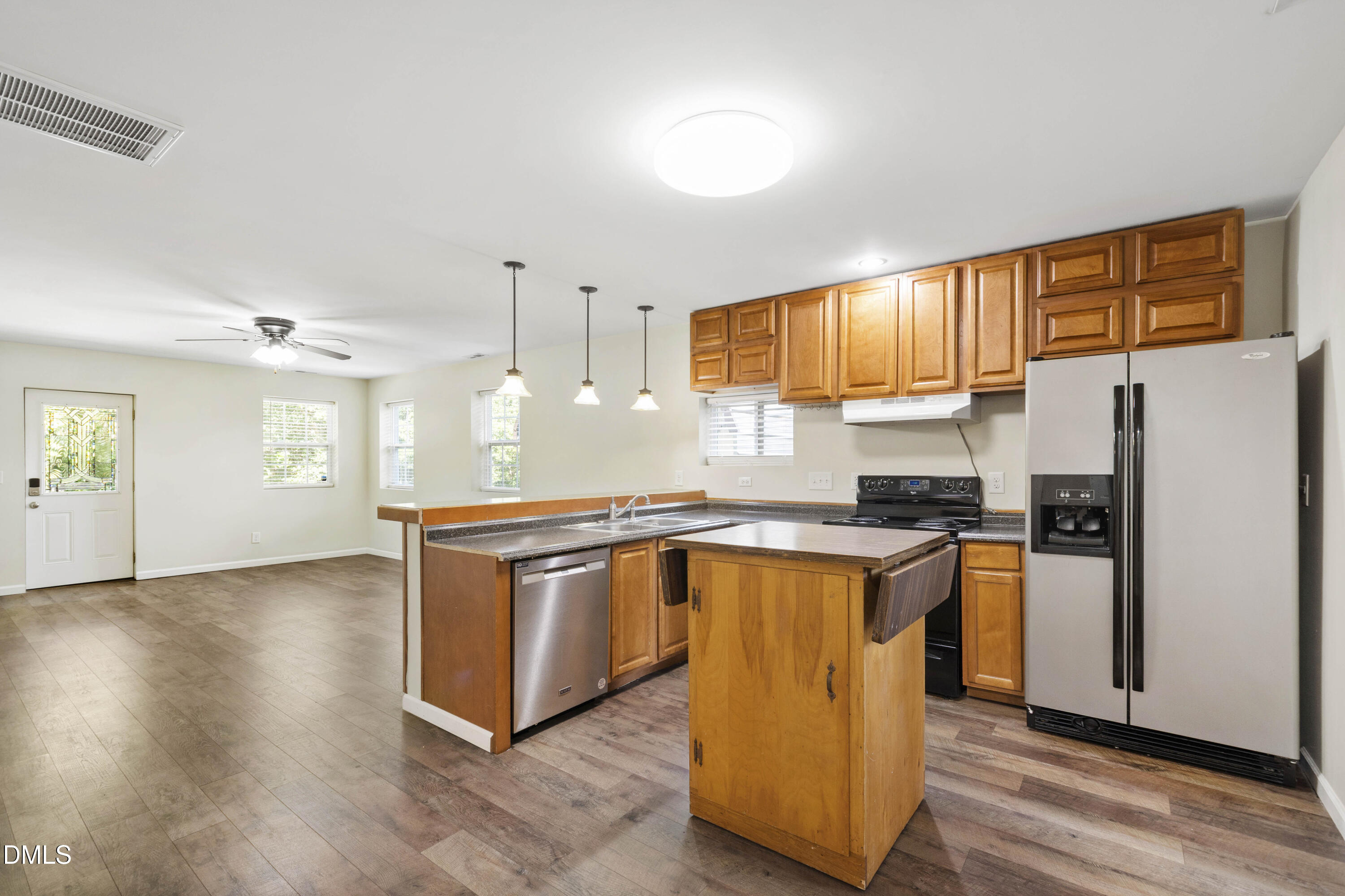 2415 Dorety Place Raleigh, NC 27604 - Photo 5 of 53 a kitchen with granite countertop wooden floors stainless steel appliances a sink and a window