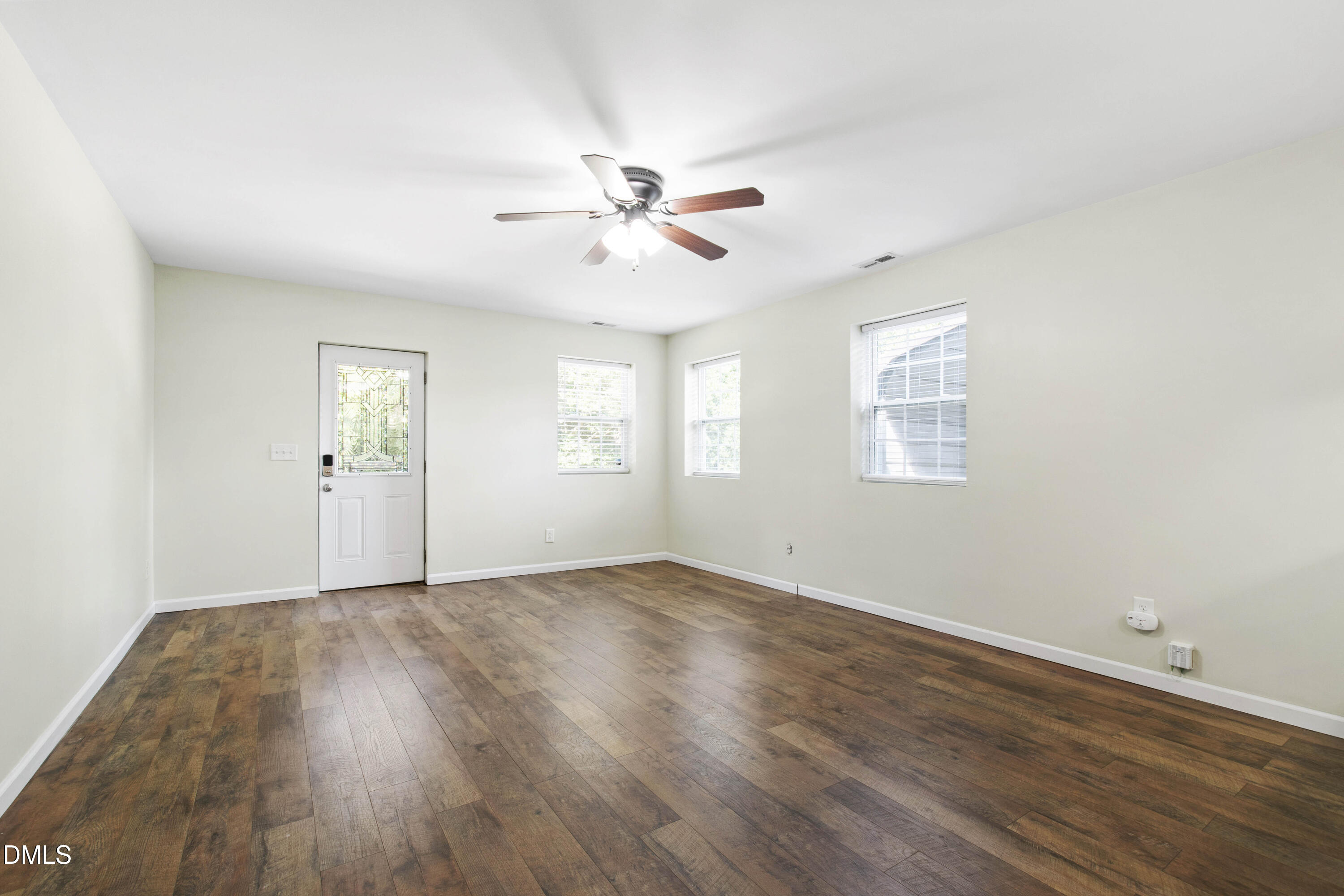 2415 Dorety Place Raleigh, NC 27604 - Photo 10 of 53 a view of an empty room with a window and wooden floor