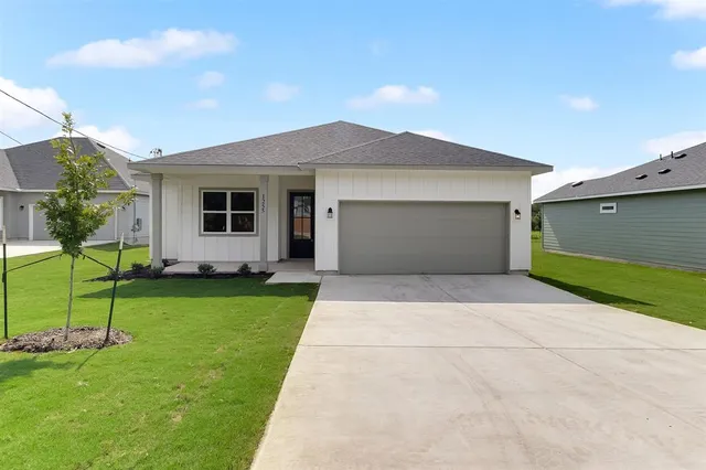 front view of a house with a yard