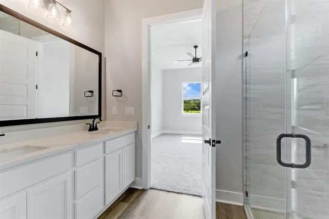 a bathroom with a double vanity sink and mirror