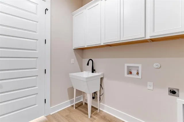 a view of a room with a sink and cabinets