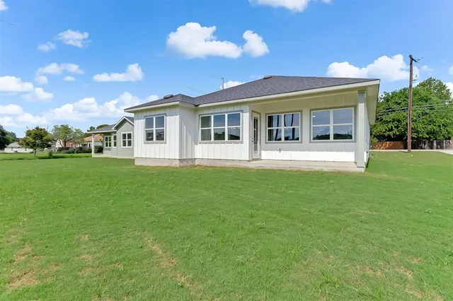 a front view of a house with a garden and yard