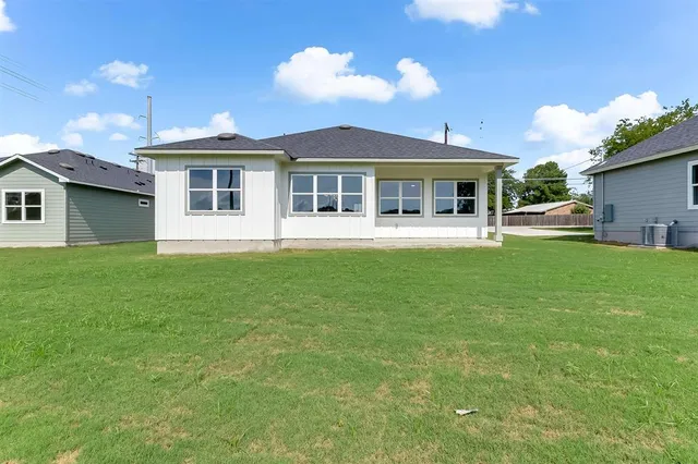 a front view of a house with a garden and yard