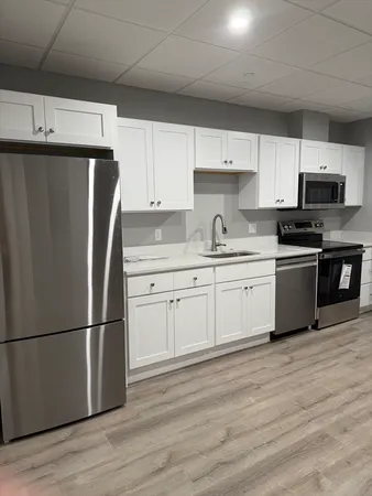 a kitchen with stainless steel appliances a refrigerator sink and cabinets