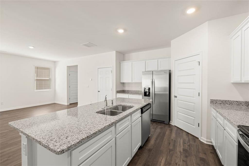 6010 Knickerbocker Street Mableton, GA 30126 - Photo 3 of 12 a kitchen with a sink stove and refrigerator