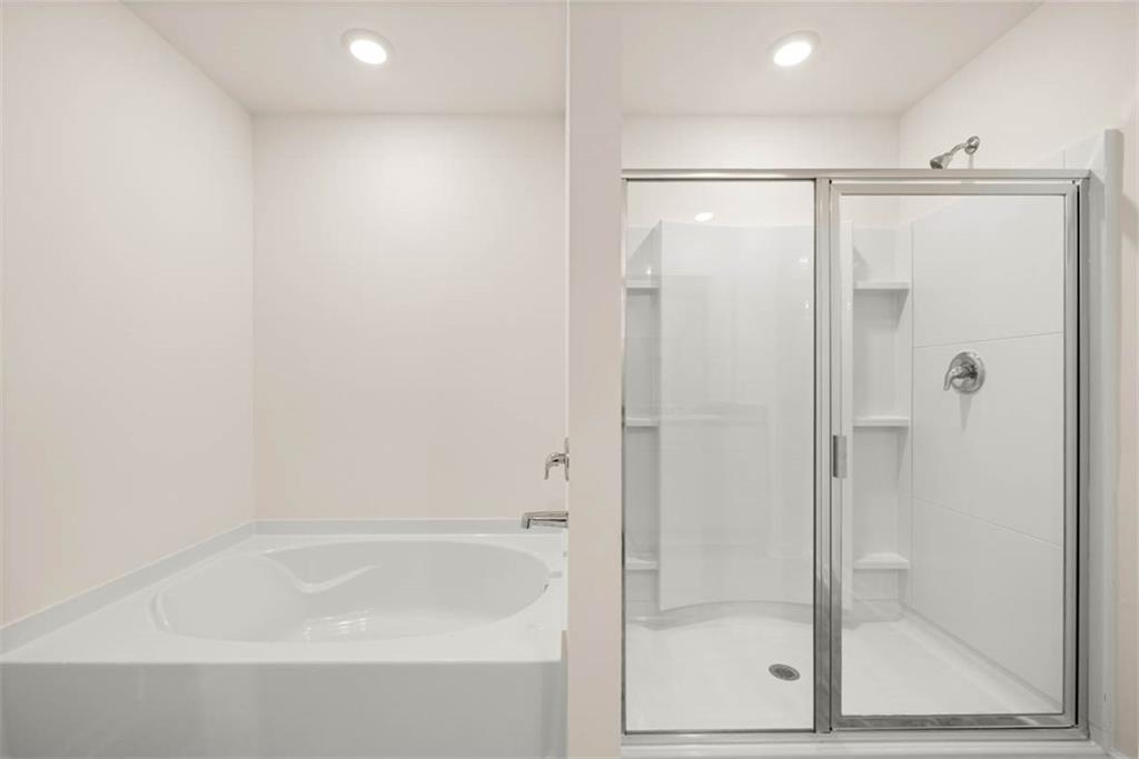 6010 Knickerbocker Street Mableton, GA 30126 - Photo 6 of 12 a bathroom with a bathtub and a shower