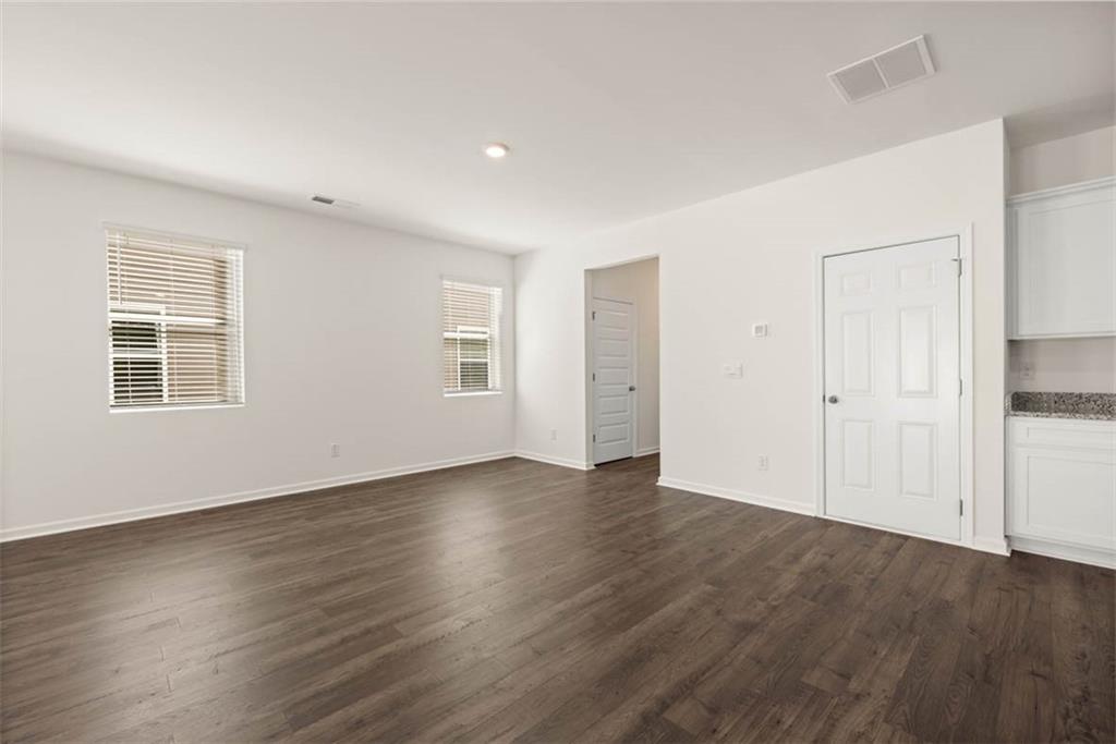 6010 Knickerbocker Street Mableton, GA 30126 - Photo 8 of 12 an empty room with wooden floor and windows