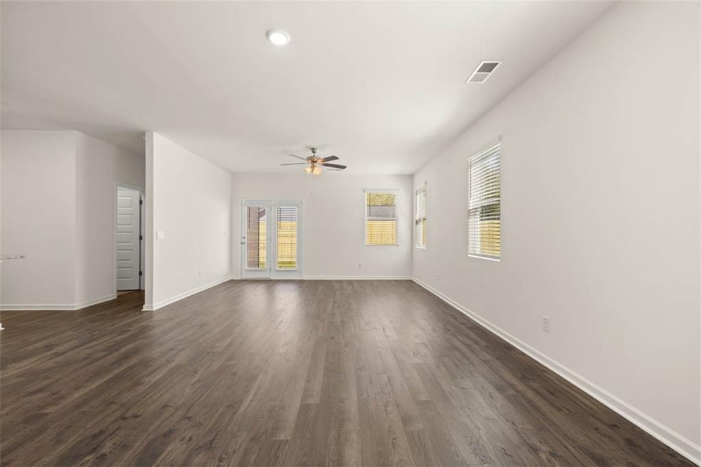 6010 Knickerbocker Street Mableton, GA 30126 - Photo 9 of 12 an empty room with wooden floor and windows